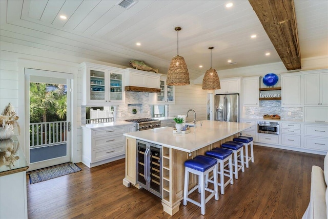 kitchen featuring stainless steel fridge with ice dispenser, wine cooler, white cabinets, and an island with sink