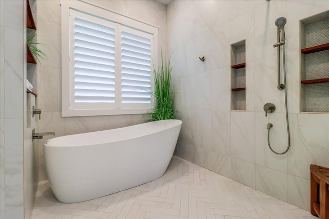 bathroom featuring plus walk in shower and tile walls