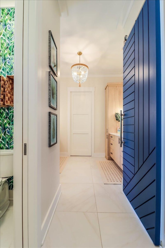 hallway featuring light tile patterned flooring, a chandelier, and ornamental molding