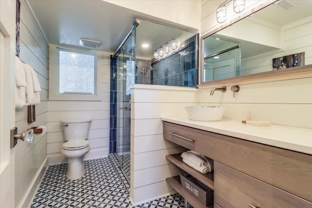 bathroom featuring an enclosed shower, vanity, and toilet