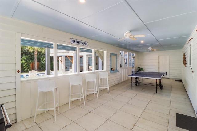 rec room with ceiling fan and light tile patterned floors