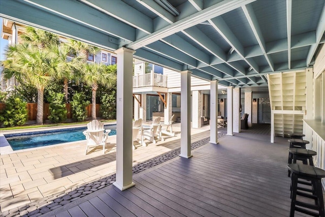 wooden deck featuring a fenced in pool