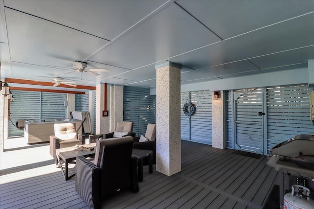 wooden deck featuring ceiling fan, an outdoor living space, and grilling area