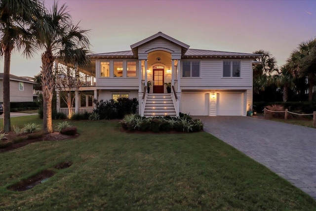 view of front of property with a lawn and a garage