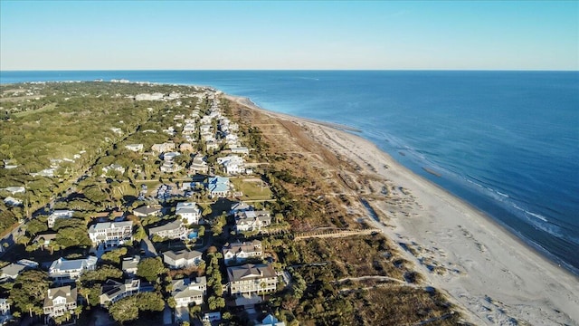 birds eye view of property featuring a water view and a beach view