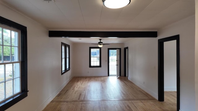 spare room with ceiling fan, beam ceiling, crown molding, and light hardwood / wood-style flooring