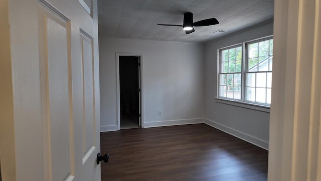 spare room with ceiling fan, dark hardwood / wood-style floors, and crown molding