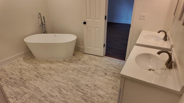 bathroom with a washtub and vanity