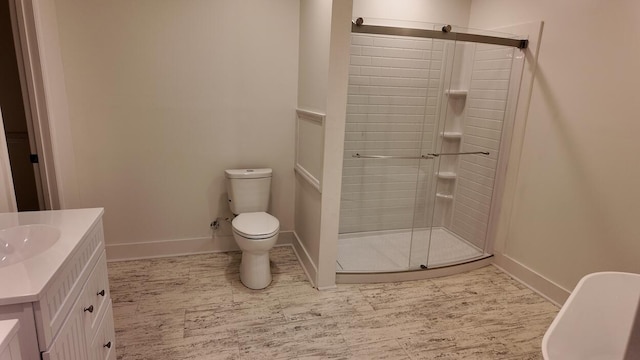 bathroom featuring vanity, toilet, and an enclosed shower