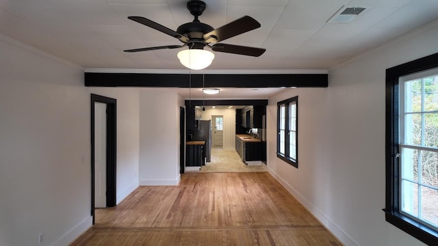 corridor featuring light hardwood / wood-style floors and crown molding