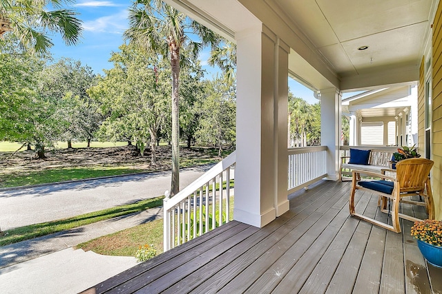 wooden terrace featuring covered porch