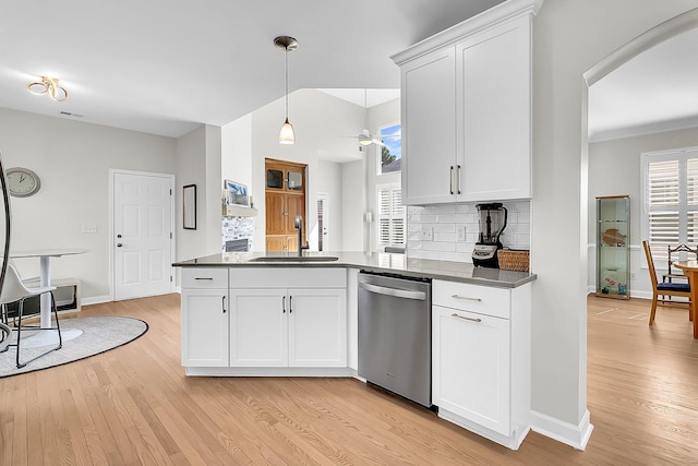 kitchen with stainless steel dishwasher, decorative backsplash, sink, and white cabinetry