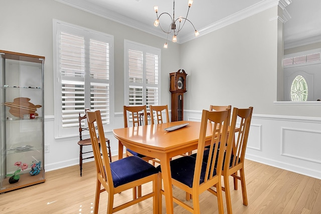 dining room featuring ornamental molding, plenty of natural light, and a notable chandelier