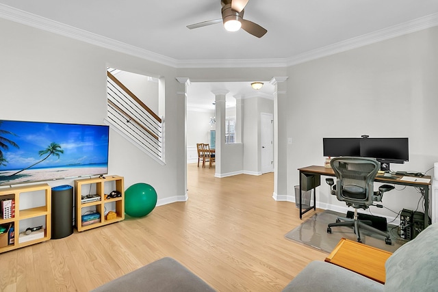 home office featuring ceiling fan, hardwood / wood-style floors, crown molding, and ornate columns