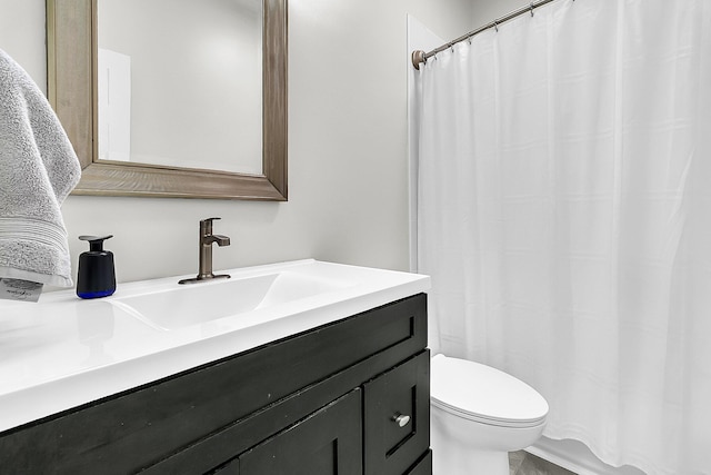 bathroom featuring toilet and vanity