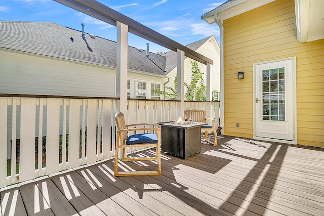 wooden terrace with an outdoor fire pit