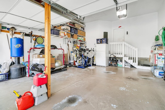 garage featuring a garage door opener and white refrigerator