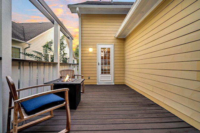 deck at dusk with a fire pit