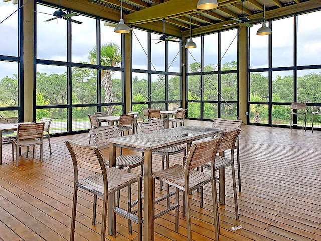 sunroom featuring ceiling fan and a healthy amount of sunlight