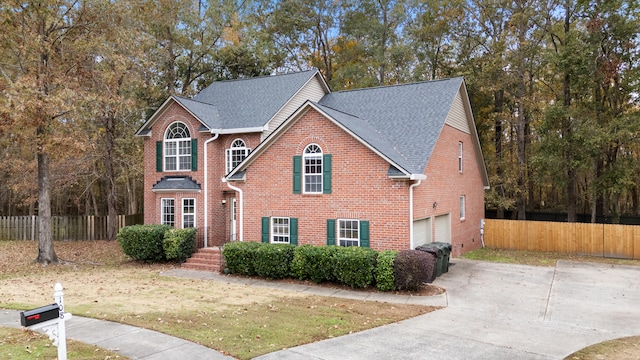 front of property with a garage and a front lawn