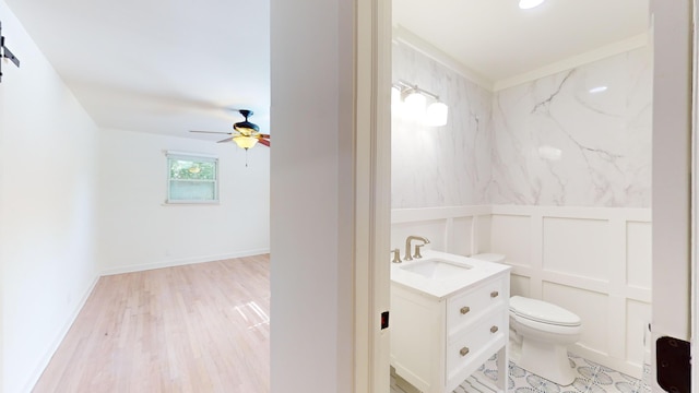 bathroom with vanity, ceiling fan, hardwood / wood-style floors, and toilet