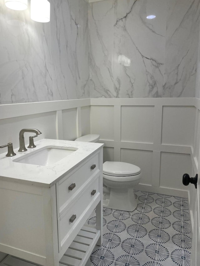 bathroom featuring vanity and toilet