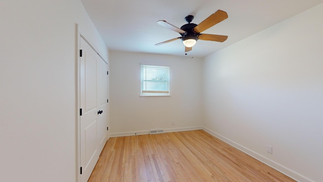 empty room featuring ceiling fan and light hardwood / wood-style floors