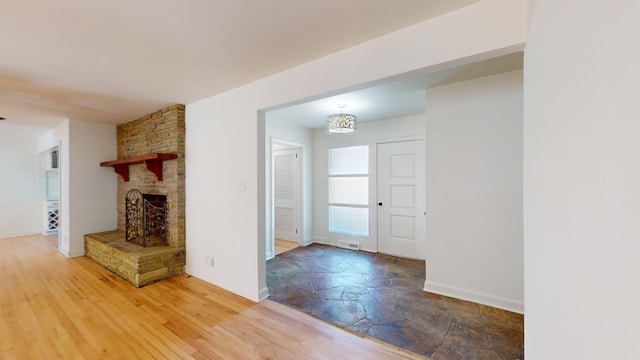 unfurnished living room featuring a fireplace and wood-type flooring