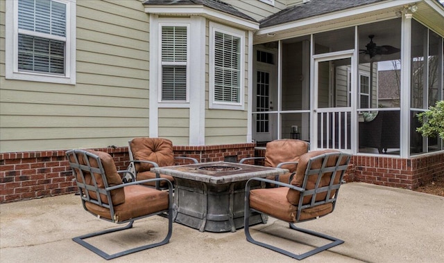 view of patio / terrace with a sunroom and a fire pit