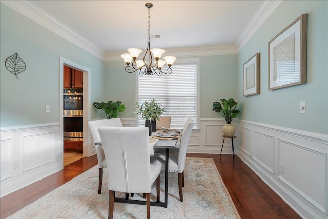 dining space featuring crown molding, a chandelier, and dark hardwood / wood-style floors