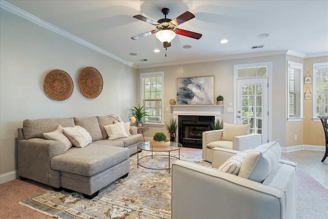 living room with ceiling fan and crown molding