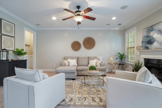 carpeted living room featuring ceiling fan and ornamental molding