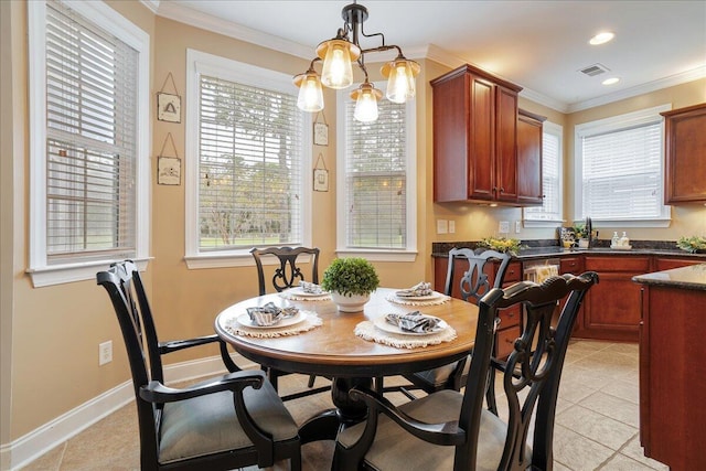 tiled dining room featuring crown molding and plenty of natural light