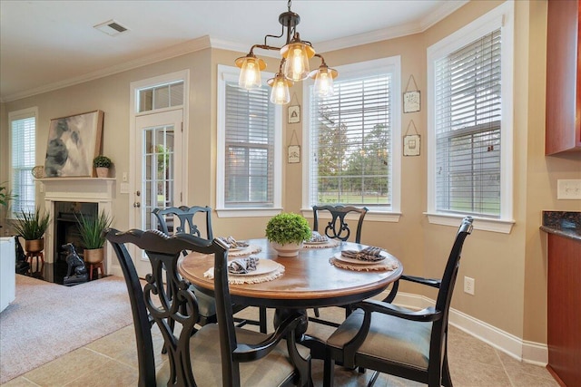 dining area featuring crown molding, a notable chandelier, and light tile patterned flooring