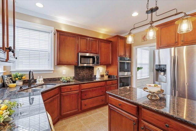 kitchen with sink, stainless steel appliances, ornamental molding, and pendant lighting