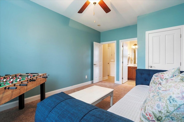 carpeted bedroom featuring ceiling fan and ensuite bath