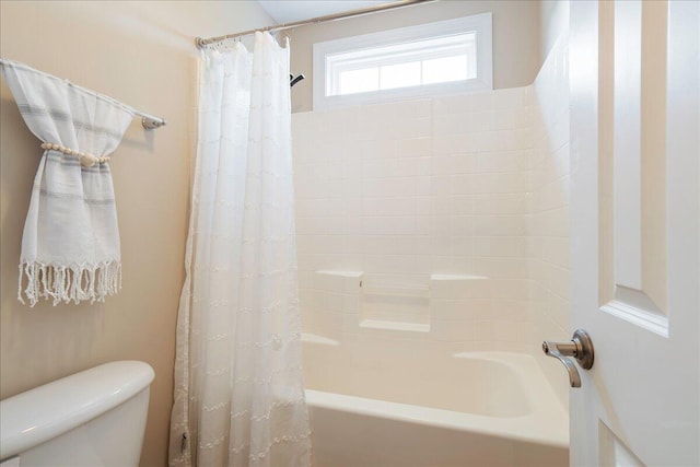 bathroom with toilet and shower / bath combination with curtain