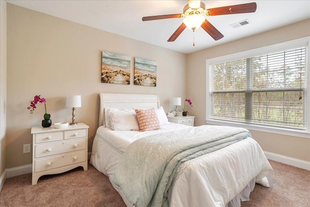 bedroom featuring light carpet and ceiling fan