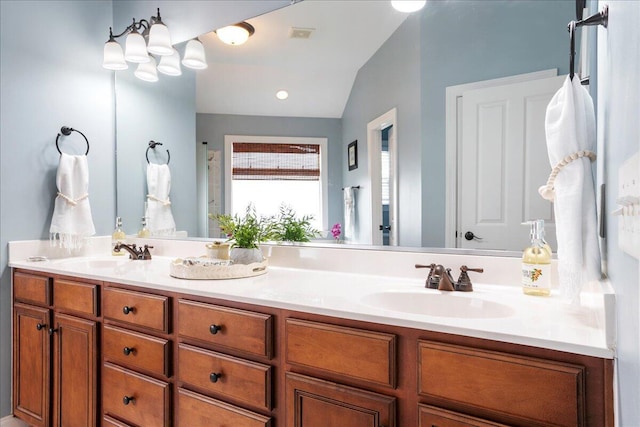 bathroom featuring lofted ceiling and vanity