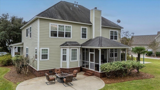 back of house with a fire pit, a sunroom, a patio area, and a yard