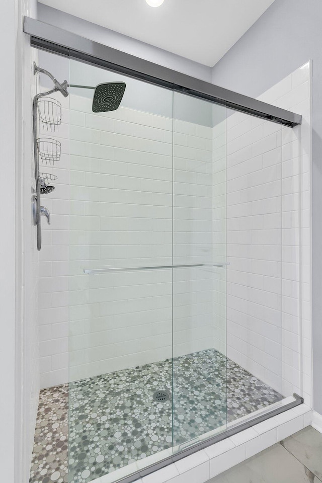 bathroom with walk in shower and tile patterned flooring