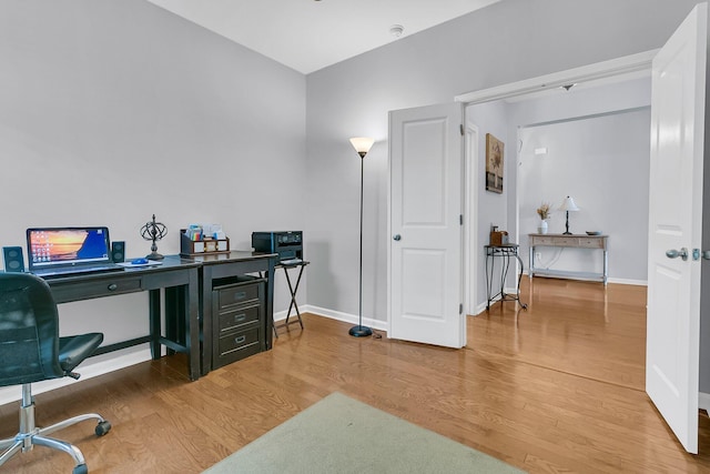 home office with hardwood / wood-style floors