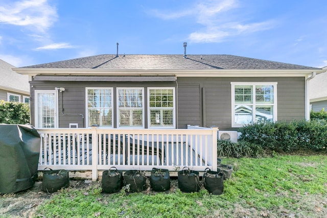 back of property featuring a wooden deck