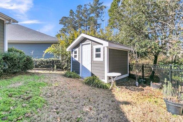 view of outbuilding featuring a lawn