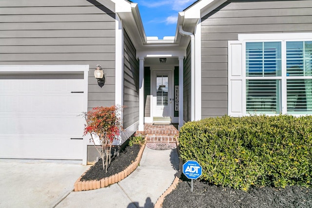 view of exterior entry featuring a garage