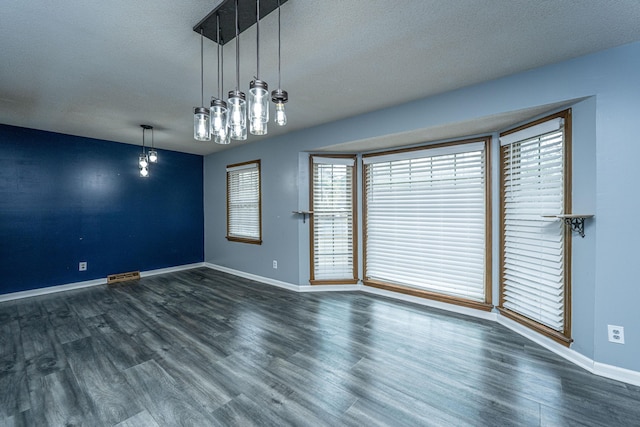 unfurnished room featuring a textured ceiling and dark wood-type flooring