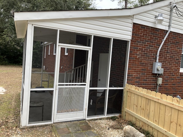 view of home's exterior with a sunroom