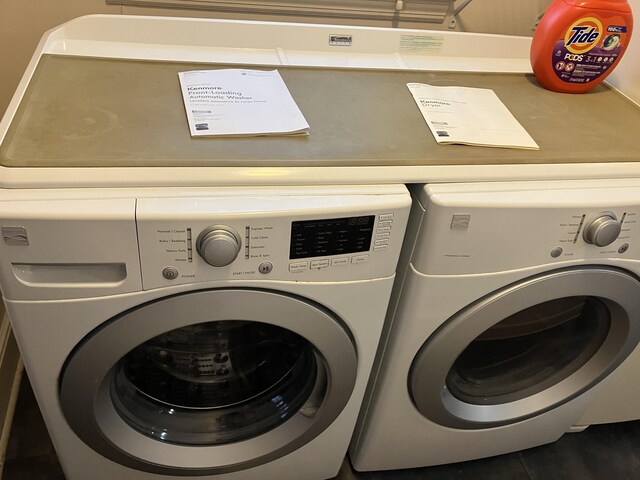 clothes washing area featuring separate washer and dryer