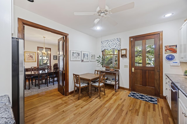 foyer with light wood-style flooring, recessed lighting, baseboards, and ceiling fan with notable chandelier