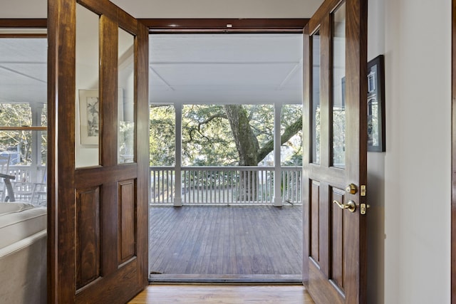 doorway featuring wood finished floors and expansive windows